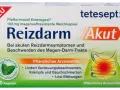 Verpackung von Reizdarm Akut mit Pfefferminzöl, magensaftresistenten Kapseln und Abbildung des Verdauungstrakts.